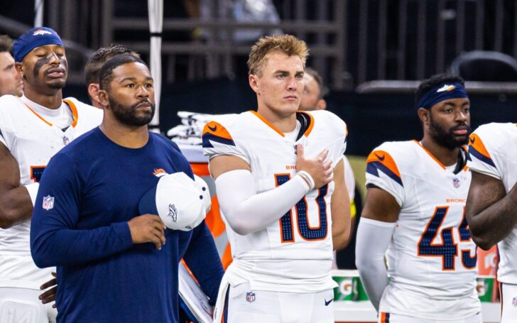 Bo Nix and teammates put their hands over their heart for the National Anthem.