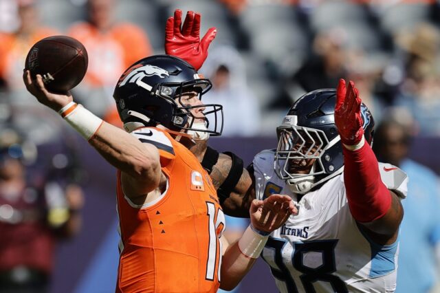 Bo Nix throws while Jeffery Simmons is in his grill.