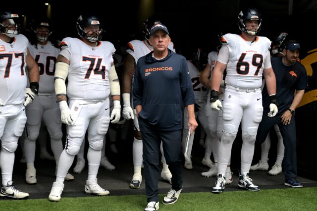Sean Payton leads the Broncos onto the field against the Chargers.