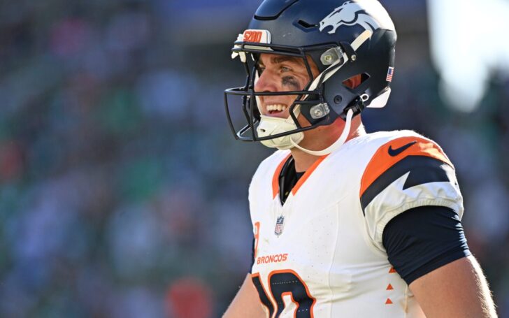 Bo Nix smiles at the end of the Broncos - Eagles game.