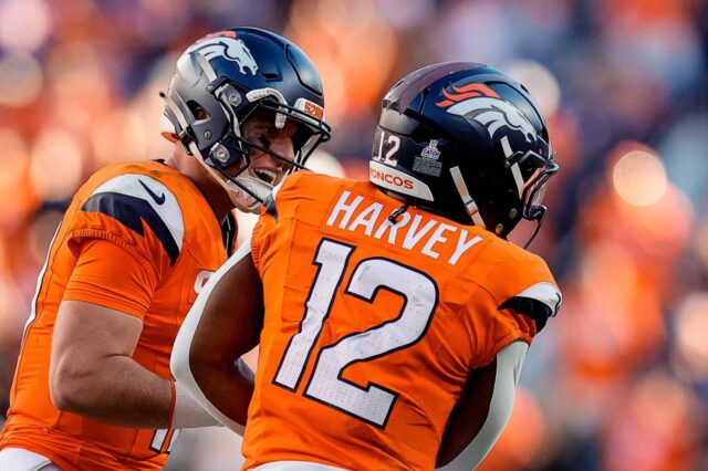 Bo Nix and RJ Harvey celebrate the running back's touchdown.